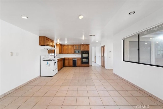 kitchen with electric range, visible vents, brown cabinets, light countertops, and a sink