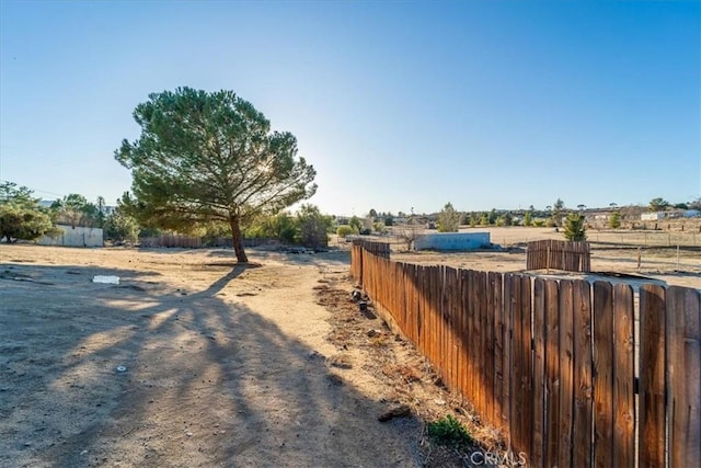 view of yard featuring a rural view and fence