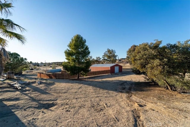 view of front of home featuring a rural view and fence