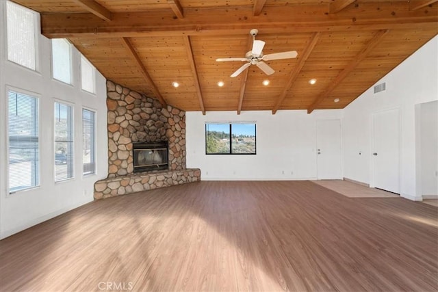 unfurnished living room featuring visible vents, wood ceiling, ceiling fan, wood finished floors, and a fireplace