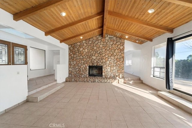 unfurnished living room with lofted ceiling with beams, light tile patterned flooring, wooden ceiling, a fireplace, and baseboards