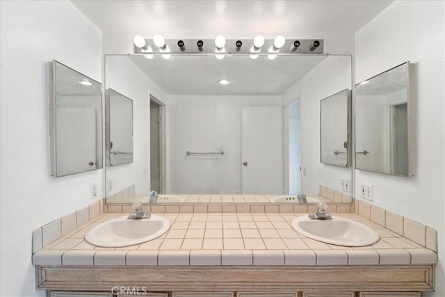 full bathroom featuring double vanity and a sink