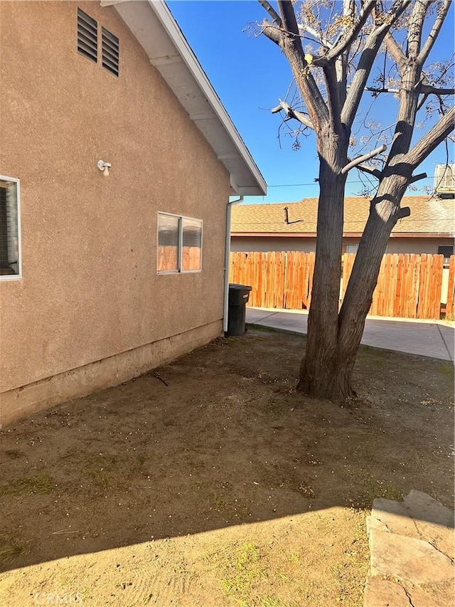 view of home's exterior featuring fence and stucco siding