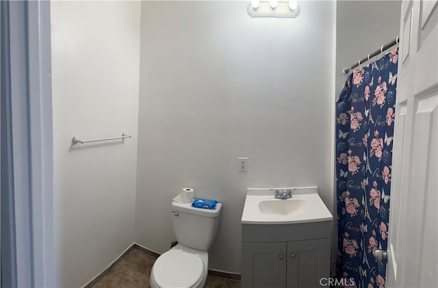 full bath featuring tile patterned flooring, vanity, and toilet