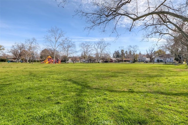 view of yard featuring a residential view and playground community