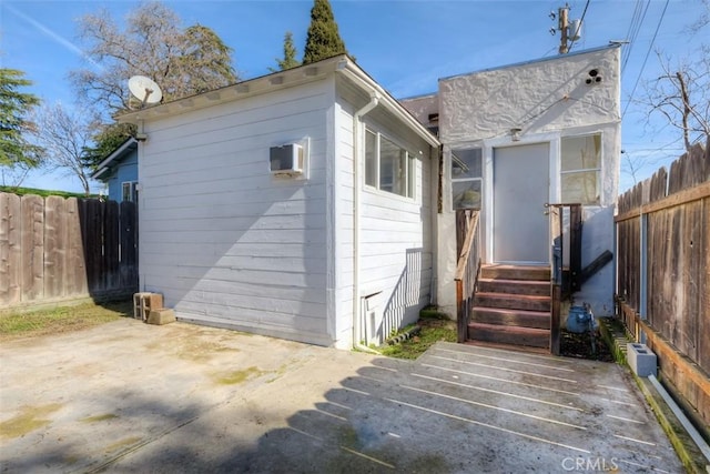 rear view of property featuring a patio area and a fenced backyard