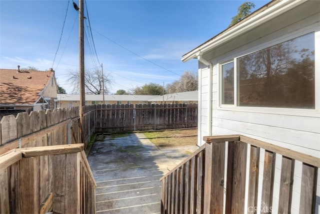 wooden terrace featuring fence