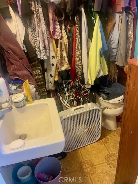 bathroom featuring toilet, a sink, and tile patterned floors