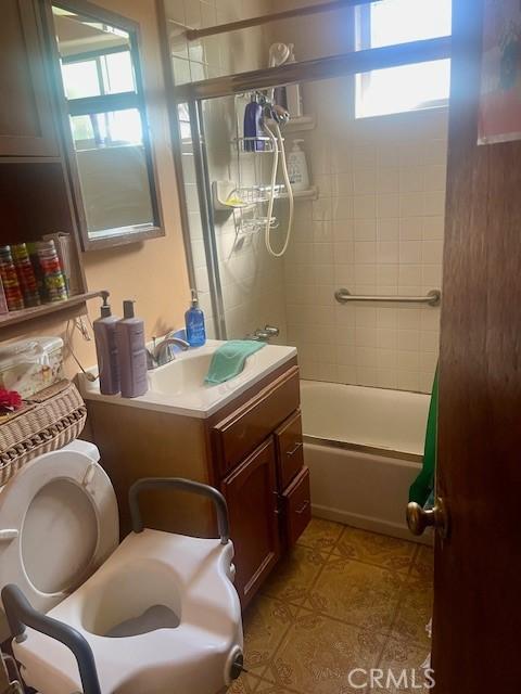 bathroom with tile patterned flooring, tub / shower combination, and vanity