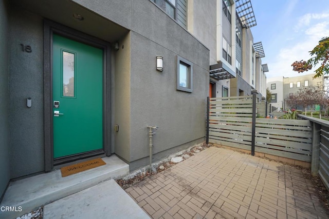 entrance to property featuring stucco siding