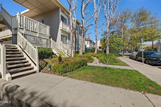 view of property with a residential view and stairs