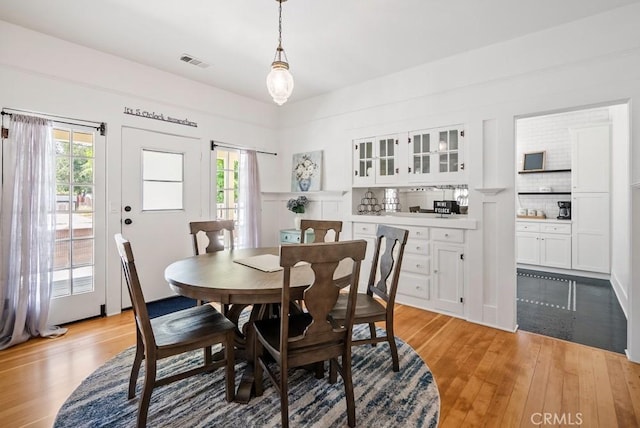 dining area with visible vents and light wood-style floors