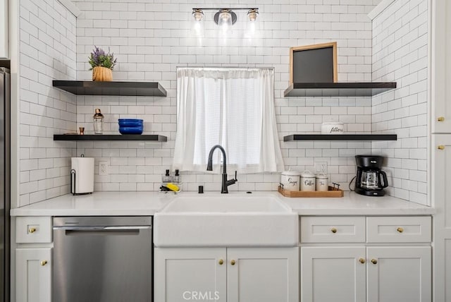 kitchen with decorative backsplash, light countertops, stainless steel dishwasher, open shelves, and a sink