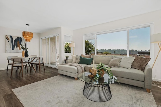 living room with dark wood-style floors and baseboards