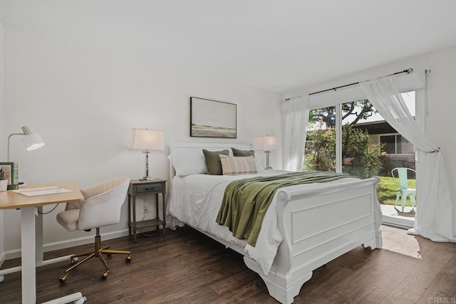 bedroom featuring access to outside, dark wood-type flooring, and baseboards