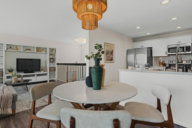 dining area with dark wood finished floors and recessed lighting