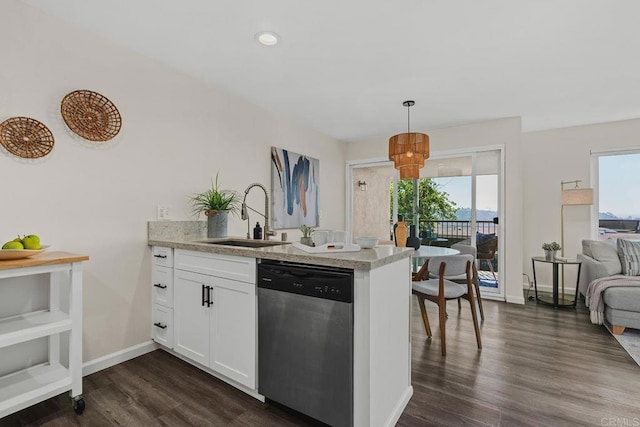 kitchen featuring a peninsula, a sink, white cabinets, dishwasher, and decorative light fixtures