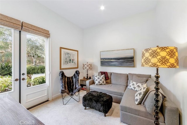 living room with light carpet, french doors, and plenty of natural light