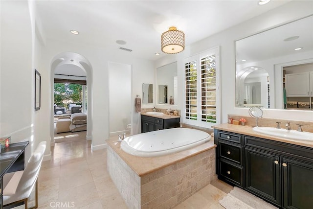 full bath with two vanities, tile patterned flooring, a garden tub, and a sink