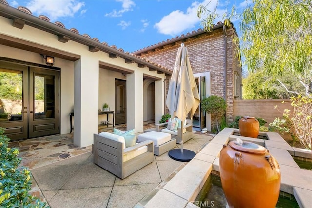 view of patio featuring french doors and fence