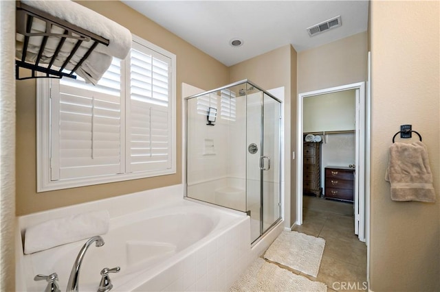 bathroom featuring a garden tub, a stall shower, tile patterned flooring, and visible vents