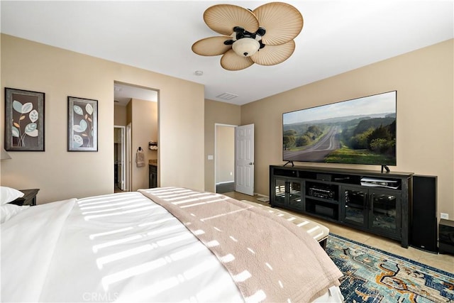 bedroom with ceiling fan, ensuite bath, and light tile patterned floors