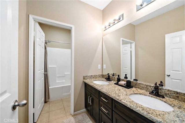 full bath featuring double vanity, a sink, and tile patterned floors