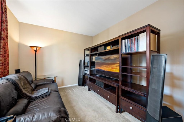 living area with light carpet and baseboards