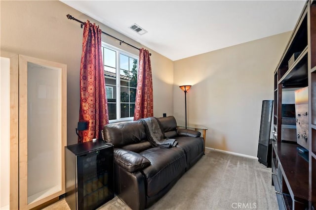 living area featuring light carpet, baseboards, and visible vents