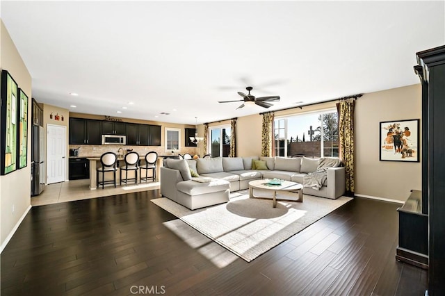 living area featuring ceiling fan, dark wood-type flooring, recessed lighting, and baseboards