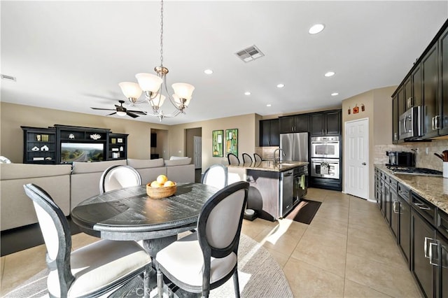 dining space with a chandelier, recessed lighting, visible vents, and light tile patterned floors