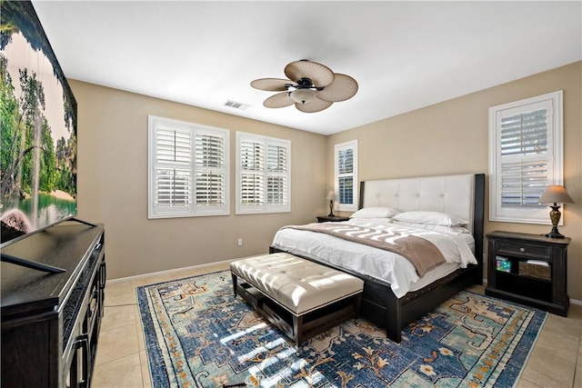 bedroom with visible vents, ceiling fan, baseboards, and light tile patterned floors