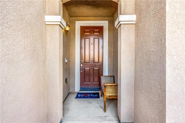 property entrance with stucco siding