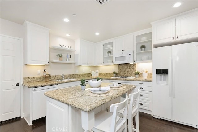 kitchen with white appliances, white cabinets, a sink, and open shelves