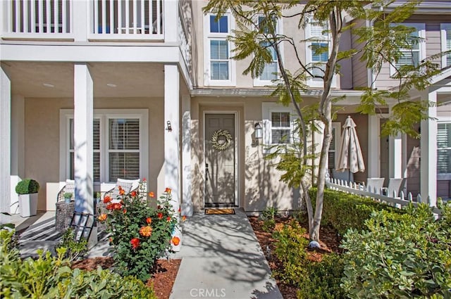 view of exterior entry featuring stucco siding