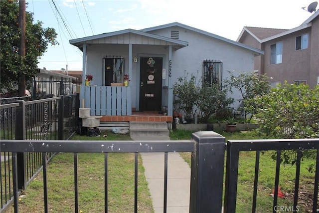 view of front facade with a fenced front yard and a gate