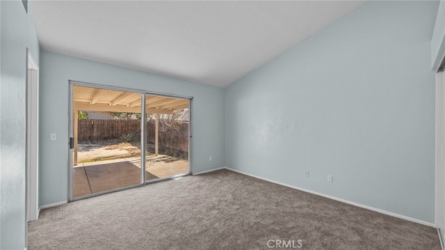 unfurnished room featuring lofted ceiling, carpet, and baseboards