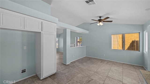 unfurnished room featuring lofted ceiling, visible vents, a ceiling fan, light tile patterned flooring, and baseboards