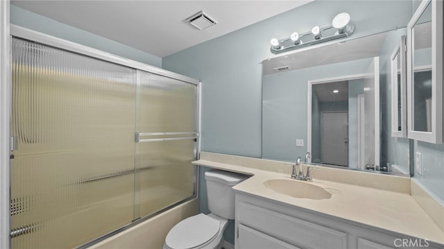 full bath with toilet, shower / bath combination with glass door, vanity, and visible vents