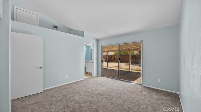 empty room featuring visible vents, vaulted ceiling, light carpet, and baseboards