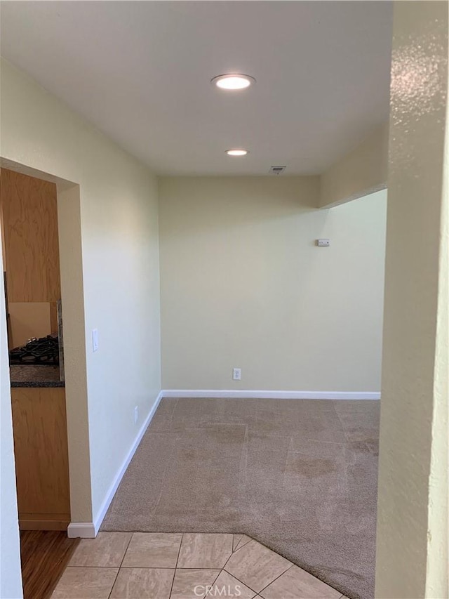 spare room with recessed lighting, visible vents, baseboards, and light colored carpet