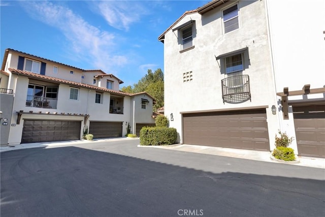 exterior space with an attached garage and stucco siding