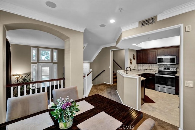 dining space featuring ornamental molding, arched walkways, visible vents, and recessed lighting