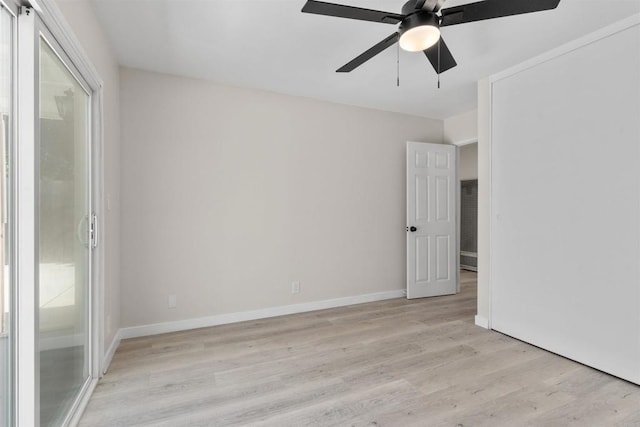 spare room with a ceiling fan, baseboards, and light wood finished floors