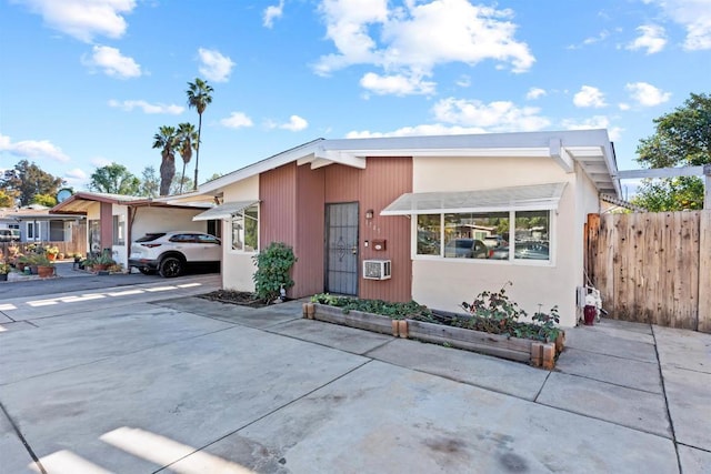 view of front of home with driveway and fence