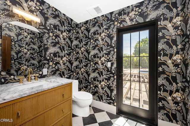 half bath with tile patterned floors, visible vents, toilet, and wallpapered walls