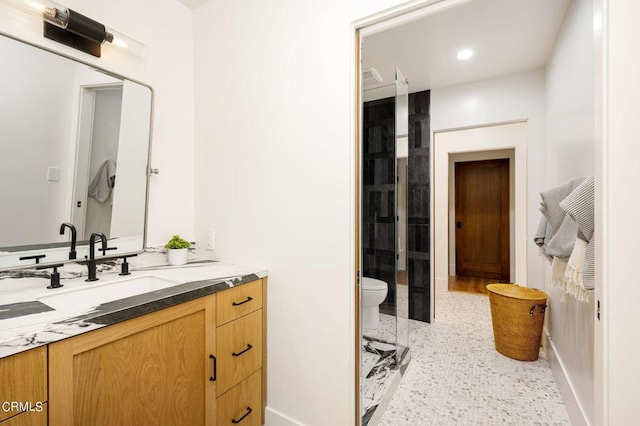 bathroom with recessed lighting, baseboards, vanity, and toilet