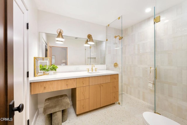 full bath featuring toilet, a shower stall, and vanity