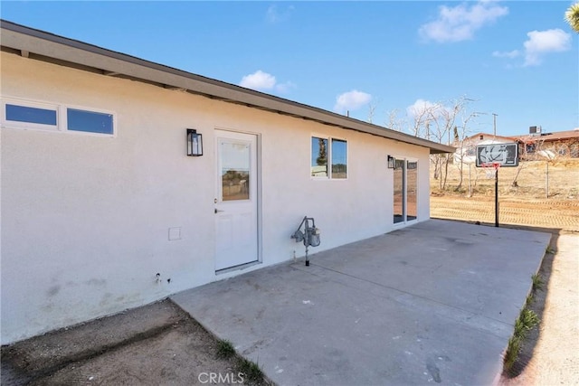 exterior space featuring a patio and stucco siding