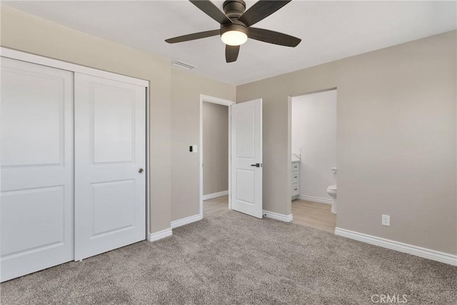 unfurnished bedroom featuring a closet, light carpet, visible vents, and baseboards